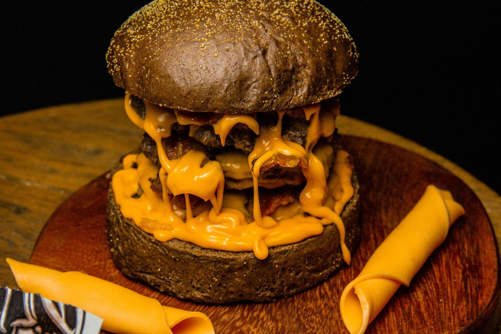 Burger au cheddar fondu qui coule sur la planche